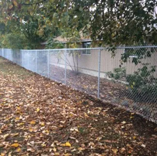 Galvanized chain link fence installed along residential property in Lane County