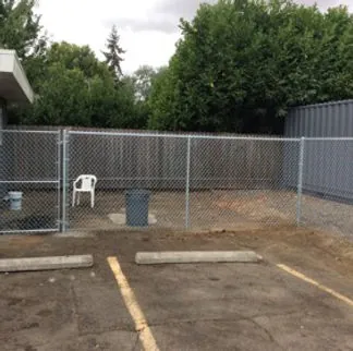 Galvanized chain link security fence with gate at commercial property